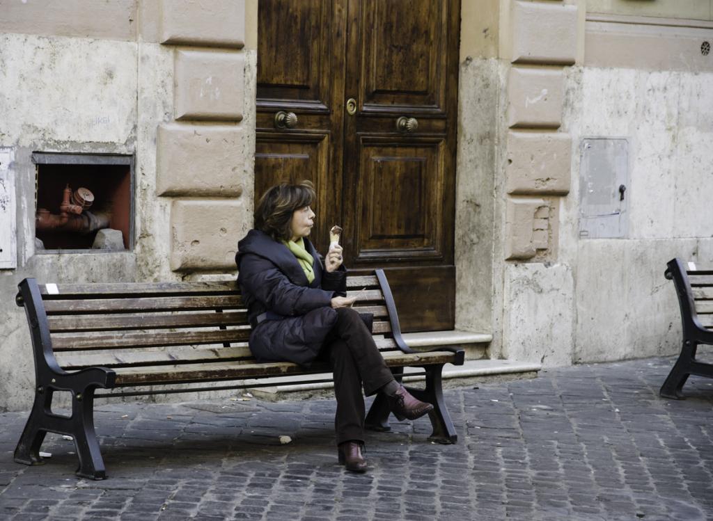 Woman eating gelato on the bench in Jewish Ghetto