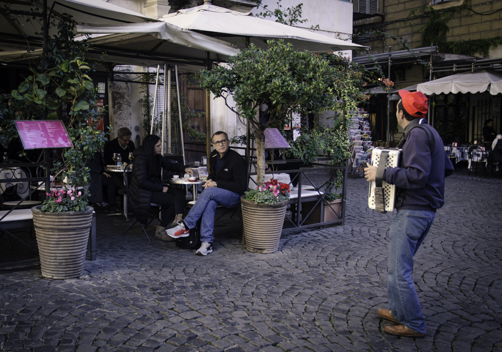 A musician playing in front of the restaurant in Monti