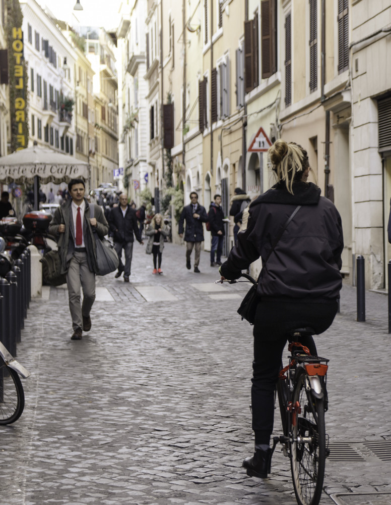 A girl cycling down Via Boschetto