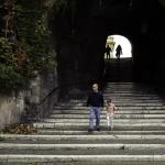 Man with a daughter walking down the steps of Salita dei Borgia
